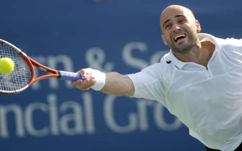 epa000246842  Andre Agassi of the United States returns a forehand against Lleyton Hewitt of Australia during the finals of the Western & Southern Financial Group Masters in Mason, Ohio Sunday, 8 August 2004. Agassi won the match 6-3, 3-6, 6-2.  EPA/MIKE SIMONS
