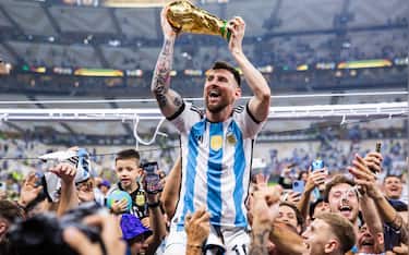 18 December 2022, Qatar, Lusail: Soccer: World Cup, Argentina - France, final round, final, Lusail Stadium, Argentina's Lionel Messi celebrates with the World Cup trophy. Photo: Tom Weller/dpa