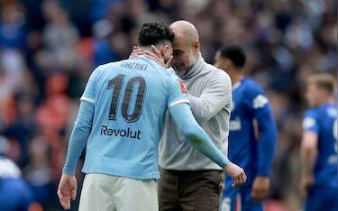 epa12964504 Manchester City's manager Pep Guardiola celebrates with Manchester City's Rayan Cherki (L) after winning the English FA Cup final match Chelsea FC against Manchester City, in London, Britain, 16 May 2026.  EPA/NEIL HALL EDITORIAL USE ONLY. No use with unauthorized audio, video, data, fixture lists, club/league logos, 'live' services or NFTs. Online in-match use limited to 120 images, no video emulation. No use in betting, games or single club/league/player publications.