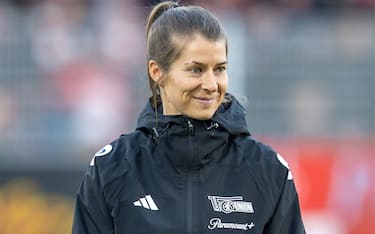 09 December 2023, Berlin: Soccer: Bundesliga, 1. FC Union Berlin - Borussia MÃ¶nchengladbach, Matchday 14, An der Alten FÃ¶rsterei. Union Berlin assistant coach Marie-Louise Eta smiles before the start of the match. Photo: Andreas Gora/dpa - IMPORTANT NOTE: In accordance with the regulations of the DFL German Football League and the DFB German Football Association, it is prohibited to utilize or have utilized photographs taken in the stadium and/or of the match in the form of sequential images and/or video-like photo series.