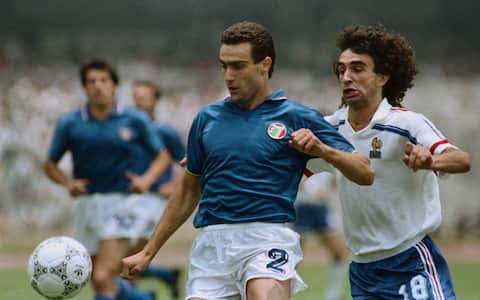 (Original Caption) Mexico City: France's Dominique Rocheteau (18) challenges Italy's Giuseppe Bergomi (2) during the first half of the second round World Cup match at Olympic stadium Mexico City June 17.