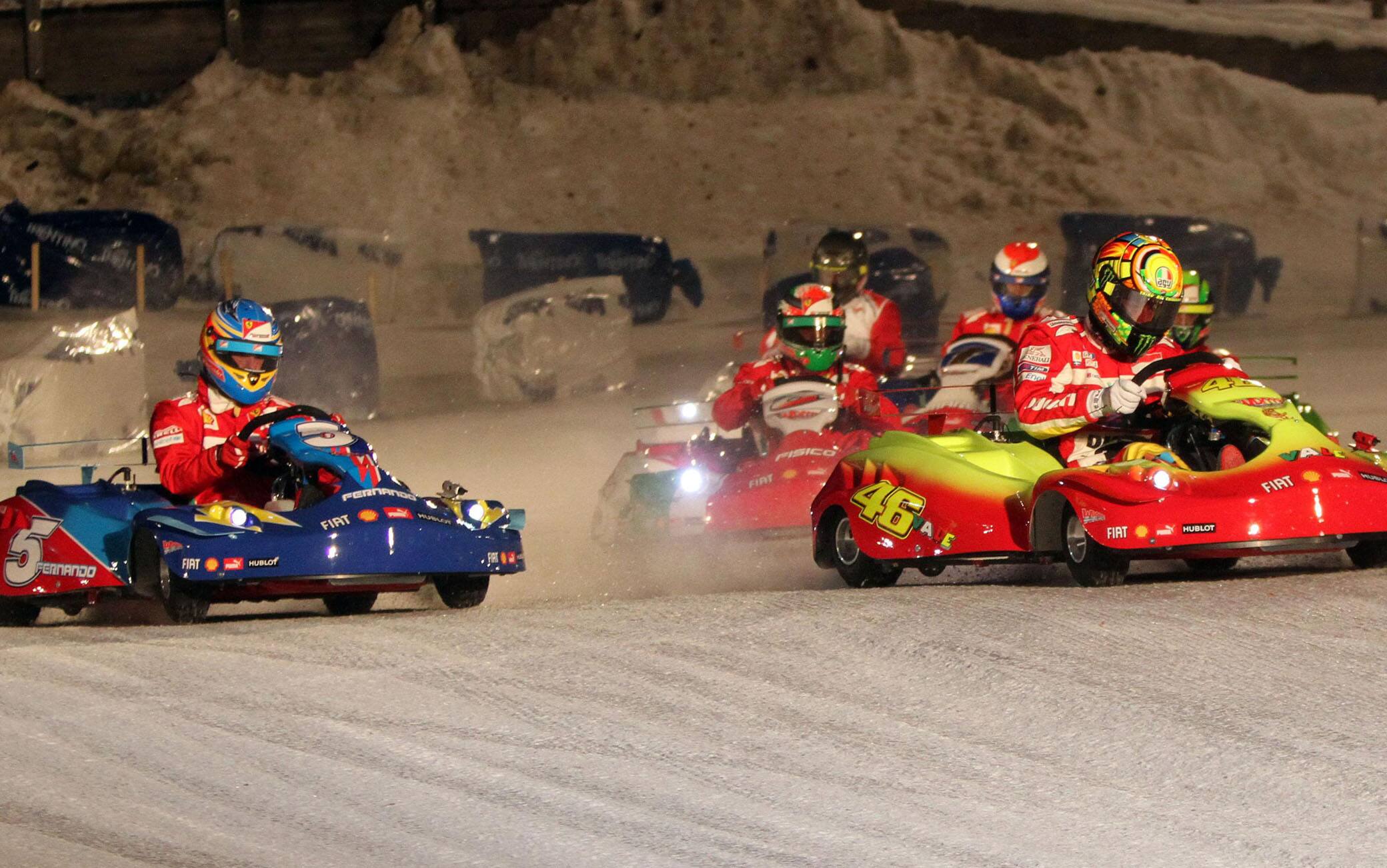 Ducati driver Valentino Rossi and his Ferrari's colleague Fernando Alonso, during the go kart race on ice ''Wrooom, F1 and MotoGP Press Ski Meeting'', Ducati and Ferrari's annual media gathering in Madonna di Campiglio, Italy,  January 13,  2012.  
MATTEO BAZZI / ANSA