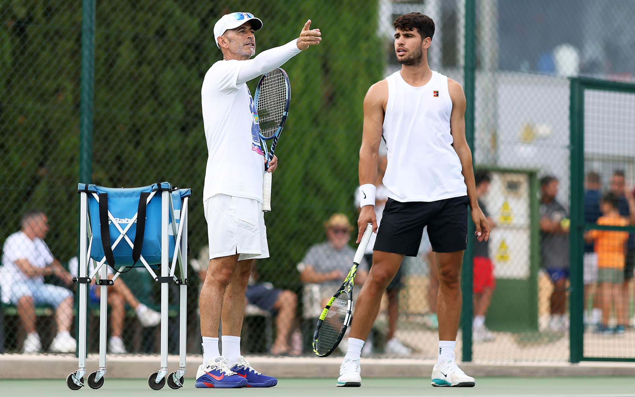MURCIA, SPAIN - JULY 30: Carlos Alcaraz of Spain listens to his coach Samuel Lopez as he trains in preparation for the Cincinnati Open and US Open at Real Sociedad Club de Campo Murcia on July 30, 2025 in Murcia, Spain. (Photo by Clive Brunskill/Getty Images)