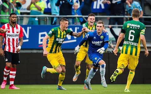 epa04880335 ADO Den Haag goalkeeper Martin Hansen (2-R) celebrates with his team mates after scoring a goal during the Dutch Eredivisie soccer match between ADO Den Haag and PSV Eindhoven, in The Hague, Netherlands, 11 August 2015.  EPA/ERWIN SPEK