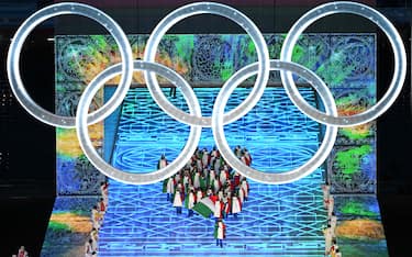Italy's flag bearer Michela Moioli leads the delegation as they enter the stadium during the opening ceremony of the Beijing 2022 Winter Olympic Games, at the National Stadium, known as the Bird's Nest, in Beijing, on February 4, 2022. (Photo by Jewel SAMAD / AFP) (Photo by JEWEL SAMAD/AFP via Getty Images)