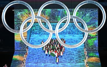 Italy's flag bearer Michela Moioli leads the delegation as they enter the stadium during the opening ceremony of the Beijing 2022 Winter Olympic Games, at the National Stadium, known as the Bird's Nest, in Beijing, on February 4, 2022. (Photo by Jewel SAMAD / AFP) (Photo by JEWEL SAMAD/AFP via Getty Images)