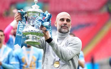 IPA84756826 - Manchester City manager Pep Guardiola celebrates with the FA Cup trophy following his sides victory over Chelsea at Wembley Stadium, London. Picture date: Saturday May 16, 2026.