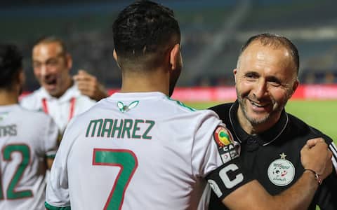 07 July 2019, Egypt, Cairo: Algeria's national team coach Djamel Belmadi embraces Algeria's Riyad Mahrez after the final whistle of the 2019 Africa Cup of Nations round of 16 soccer match between Algeria and Guinea at the 30 June Stadium. Photo: Gehad Hamdy/dpa