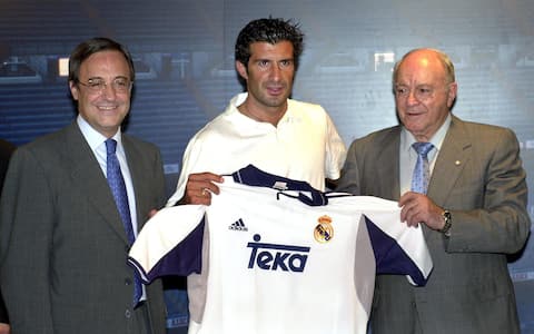 MD29 - 20000724 - MADRID, SPAIN : Real Madrid President Florentino Perez (l) and honorary chairman Alfredo di Stefano (r) present Portuguese international Luis Figo his future jersey during his official presentation as Real Madrid's new signing, Monday, 24 July, 2000. Figo's 70 million dollar-move from FC Barcelona to Primera Division rivals Real Madrid will make him the world's most expensive footballer.  (ELECTRONIC IMAGE)EPA PHOTO EFE/JOSE HUESCA/ell/gh