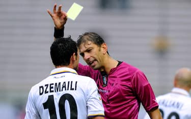 PARMA, ITALY - OCTOBER 31:  Referee Paolo Tagliavento shows a yellow card to Blerim Dzemaili of Parma FC during the Serie A match between Parma and Chievo at Stadio Ennio Tardini on October 31, 2010 in Parma, Italy.  (Photo by Claudio Villa/Getty Images) *** Local Caption *** Paolo Tagliavento;Blerim Dzemaili