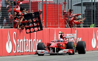 Ferrari Formula One driver Fernando Alonso of Spain celebrates with his team after passing the finish line as winner of the German Formula One Grand Prix in Hockenheim, Germany,  Sunday, July 25, 2010. (AP Photo/Martin Meissner)