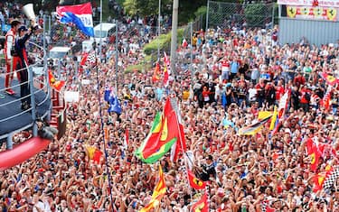 MONZA, ITALY - SEPTEMBER 08:  Sebastian Vettel of Germany and Infiniti Red Bull Racing celebrates on the podium after winning the Italian Formula One Grand Prix at Autodromo di Monza on September 8, 2013 in Monza, Italy.  (Photo by Mark Thompson/Getty Images)