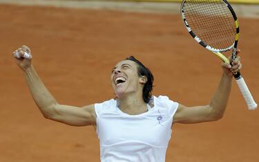 epa02182497 Francesca Schiavone of Italy reacts at beating Caroline Wozniacki of Denmark at their fourth round match for the French Open tennis tournament at Roland Garros in Paris, France, 01 June 2010.  EPA/CHRISTOPHE KARABA