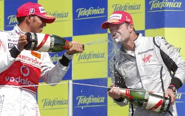 epa01834804 Brazilian Formula One driver Rubens Barrichello (R) of Brawn GP and British Formula One driver Lewis Hamilton of McLaren Mercedes celebrate on the podium after winning the Grand Prix of Europe at the Valencia Street Circuit in Valencia, Spain, 23 August 2009. Barrichello arrived in the first position, Hamilton arrived second.  EPA/FELIX HEYDER
