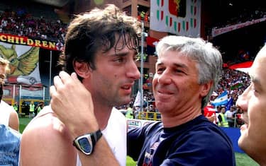 Genoa forward Diego Milito, of Argentina, left, is hugged by coach Gian Piero Gasperini at the end of a Serie A soccer match between Genoa and Lecce, in Genoa's Luigi Ferraris stadium, Sunday, May 31, 2009. Milito will be going to Inter Milan at the end of the season. (AP Photo/Italo Banchero)